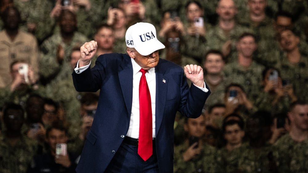 President Donald Trump dances in front of troops.