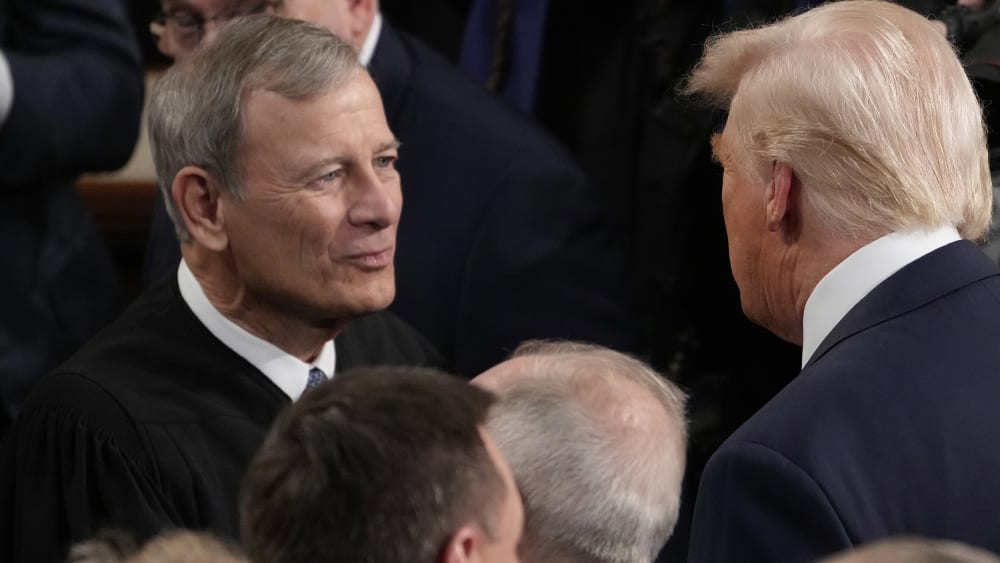 President Donald Trump greets Chief Justice John Roberts before he addresses a joint session of Congress at the U.S. Capitol.