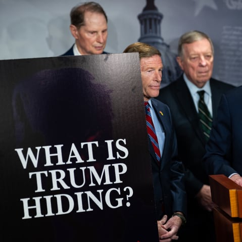 From left: Senator Ron Wyden, Senator Richard Blumenthal, Senator Dick Durbin, Senate Minority Leader Chuck Schumer, and Senator Jeff Merkley. On the left, a poster board that reads "WHAT IS TRUMP HIDING?"