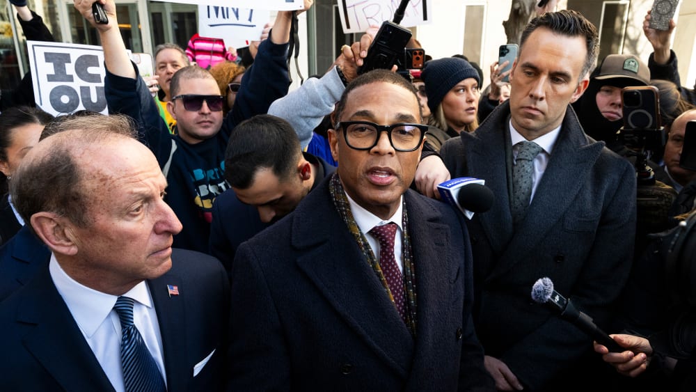 Don Lemon, center, surrounded by media and others.