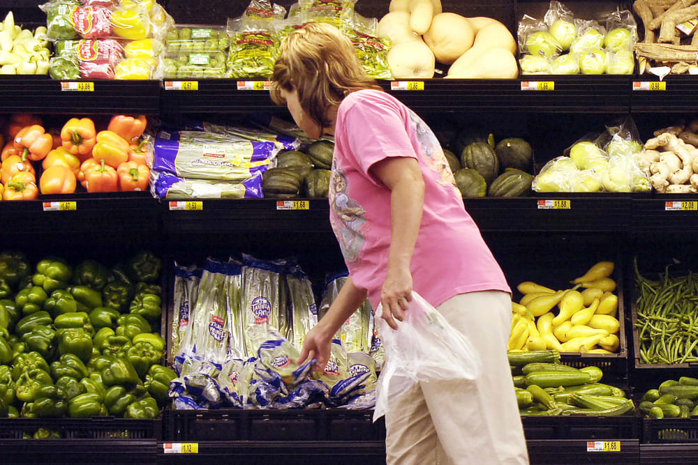A shopper looks at produce at a Wal-Mart store in Rogers, AR.