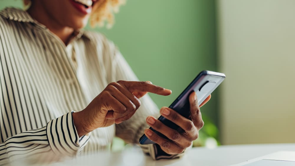 African American woman using social media on her phone.