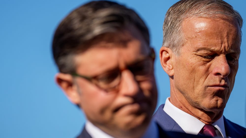 Speaker of the House Mike Johnson and Senate Majority Leader John Thune both looking down and disappointed at a news conference.