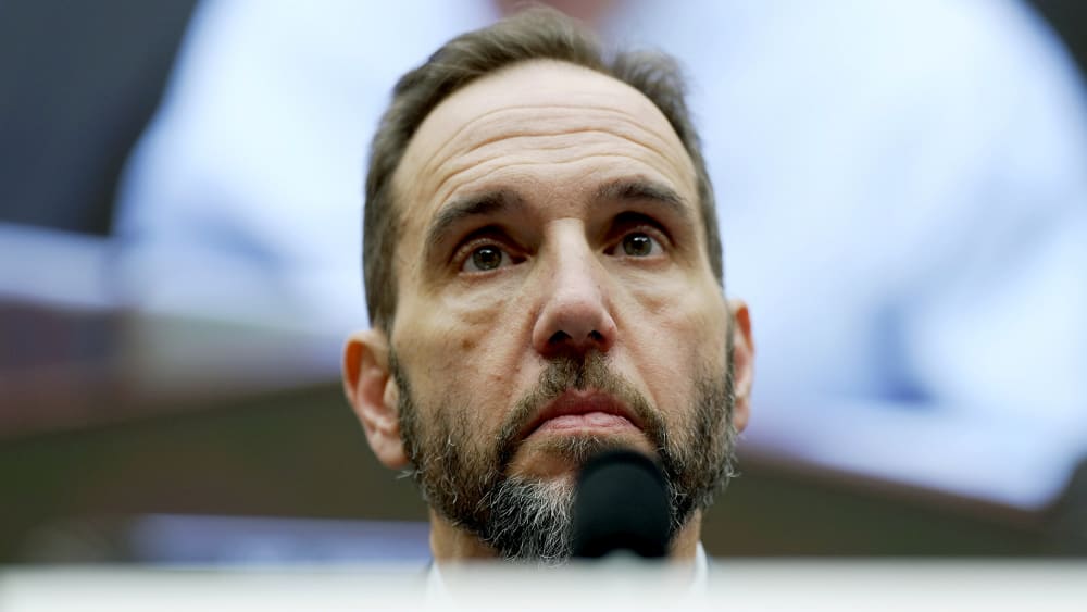 A closeup of Jack Jmith's face is photographed from below.