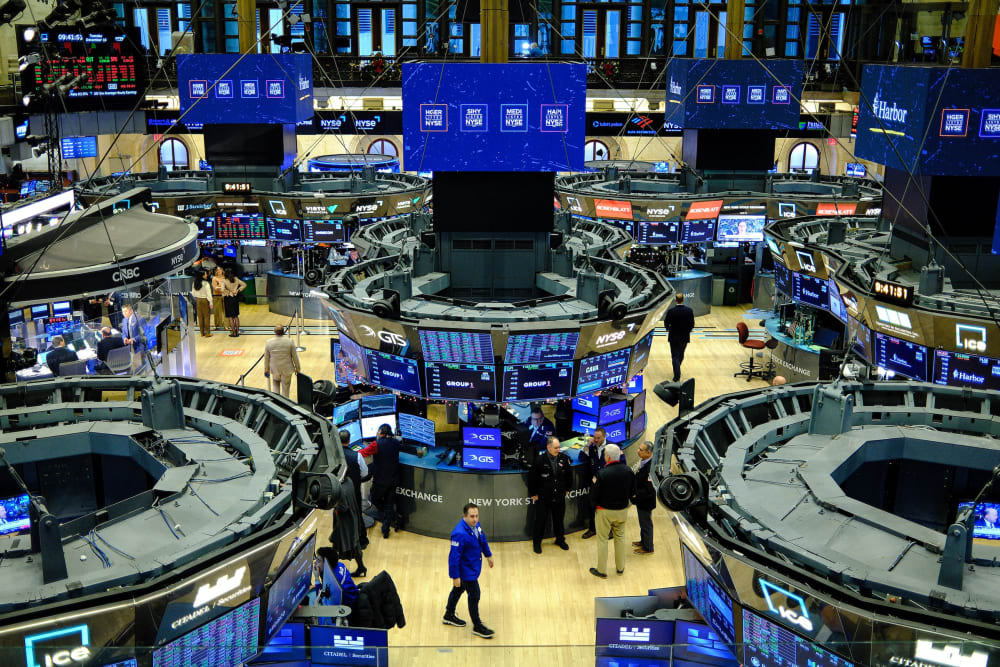 Traders work on the floor of the New York Stock Exchange at the opening bell in New York.