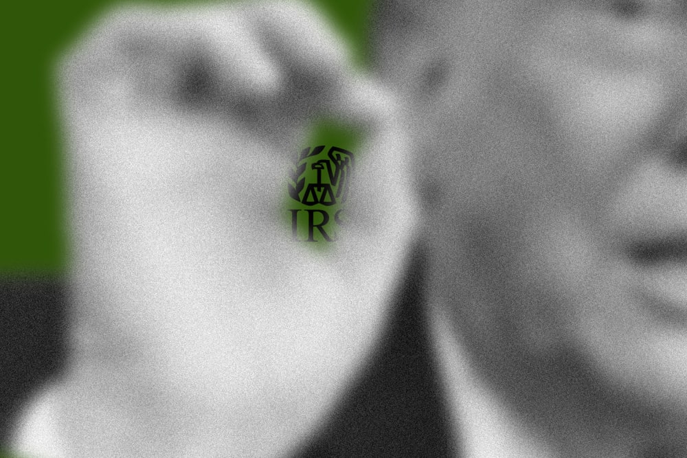 A photo illustration showing the IRS logo behind Trump's pinched fingers