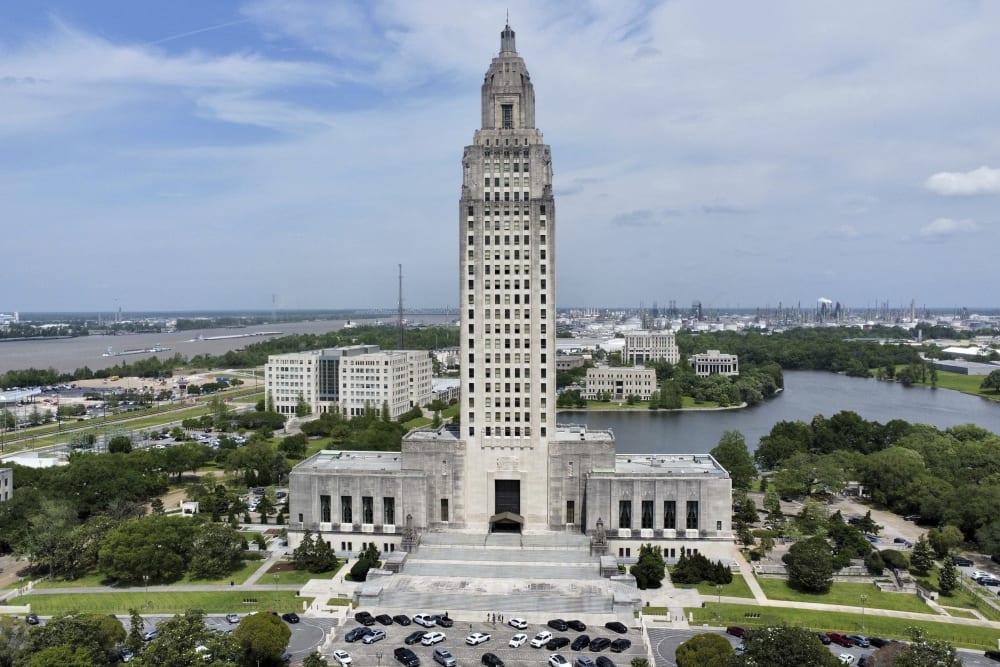 LA state capitol building photographed from above. The whole building and its surroundings are visible.