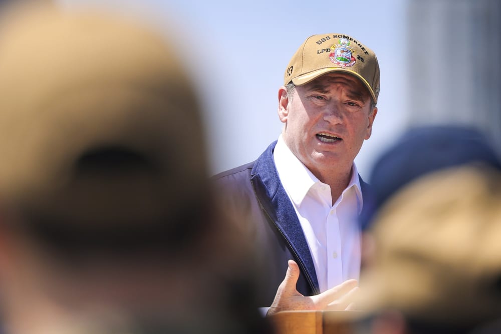 John Phelan is seen among the soldiers standing in front of him.