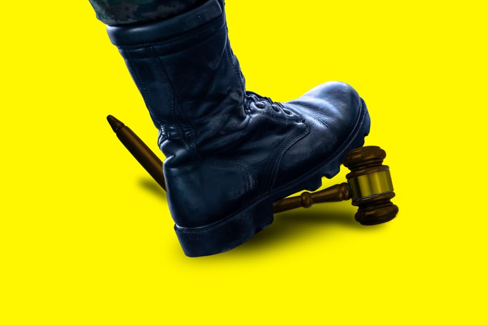 An illustration of a black military style book breaking a judge's gavel