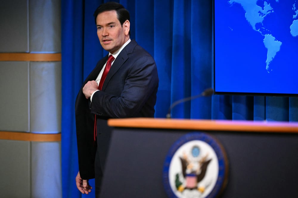 Marco Rubio arrives to speak during an end-of-year press conference.