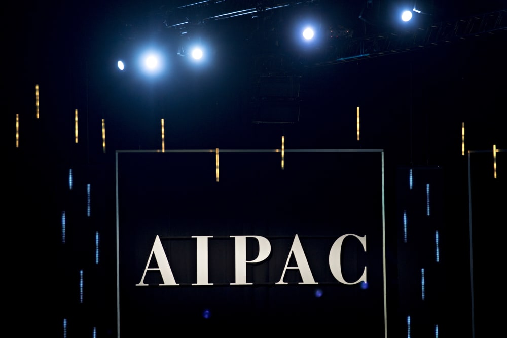 The word AIPAC is seen on a black background.