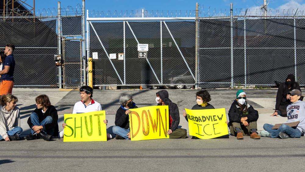 Protesters and activists sit in front of a gate to the Immigration and Customs Enforcement facility on Sept. 5, 2025 in Broadview, IL.