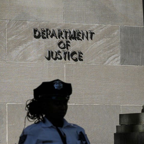 A police officer stands guard outside the US Department of Justice building in Washington, D.C.