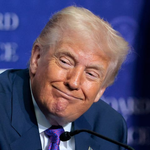 President Donald Trump looks on during speeches at the inaugural meeting of the Board of Peace.