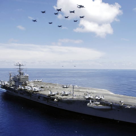 The US Navy (USN) Nimitz-class aircraft carrier USS ABRAHAM LINCOLN (CVN 72) and aircraft assigned to Carrier Air Wing Two (CVW-2) perform an aerial demonstration in the South China Sea.