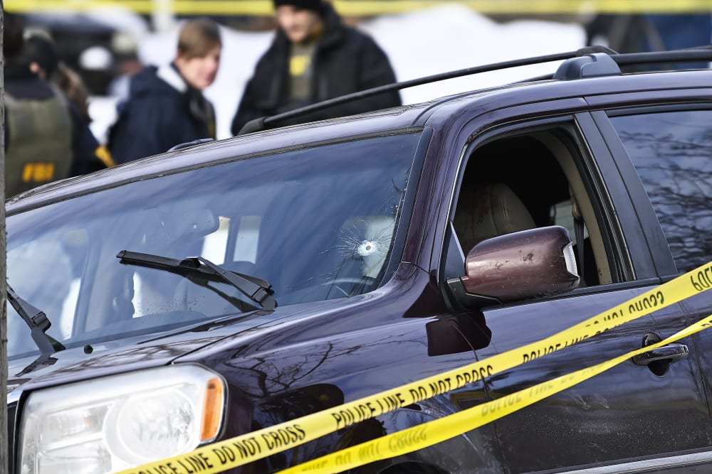 Police tape surrounds a vehicle suspected to be involved in a shooting by an ICE agent during federal law enforcement operations in Minneapolis, NM.