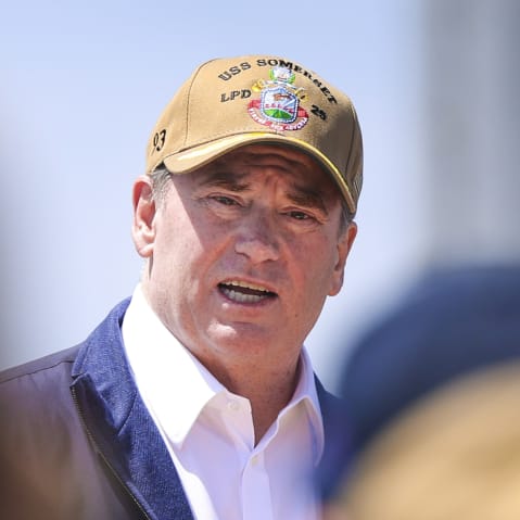 John Phelan is seen among the soldiers standing in front of him.