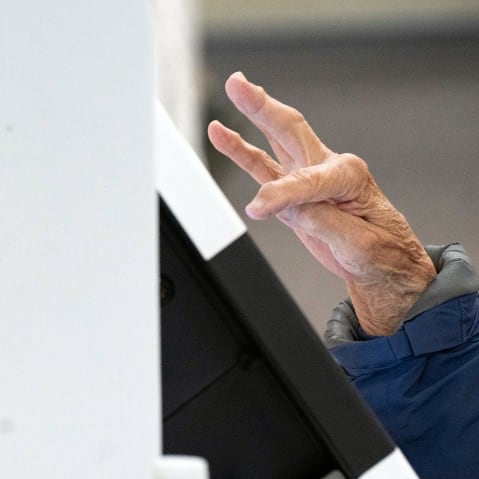 A person votes during early voting at a polling station in Black Mountain, N.C.
