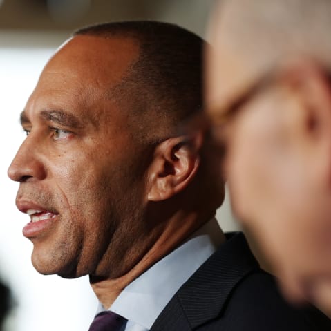 Hakeem Jeffries is talking while Chuck Schumer stands next to him.