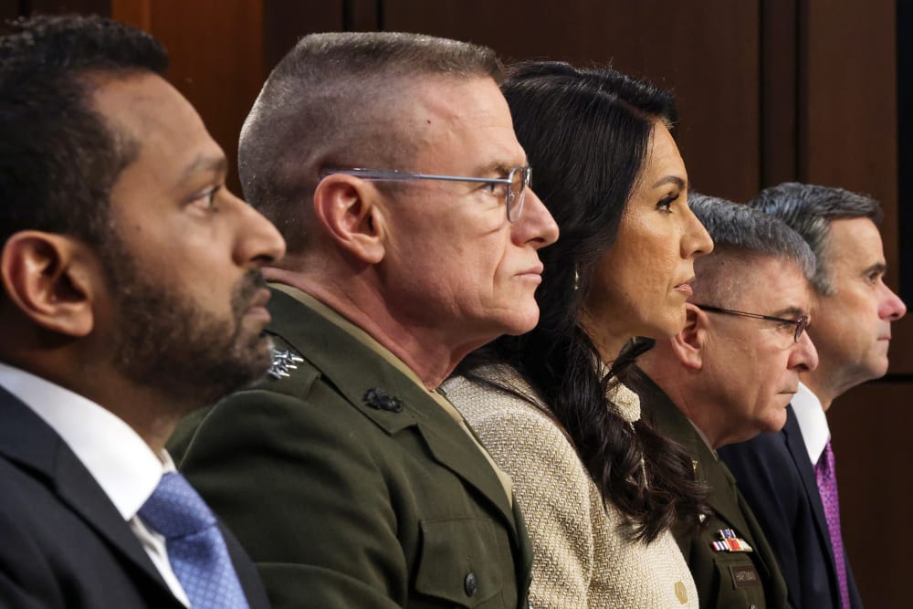 Multiple people can be seen sitting next to each other in this closeup profile shot.