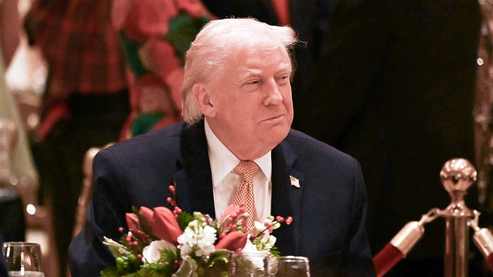 US President Donald Trump attends a Christmas dinner on Dec. 24 at his Mar-a-Lago resort in Palm Beach, FL.