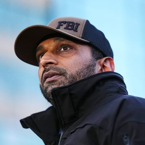 Kash Patel looks in a medium frame shot from below.