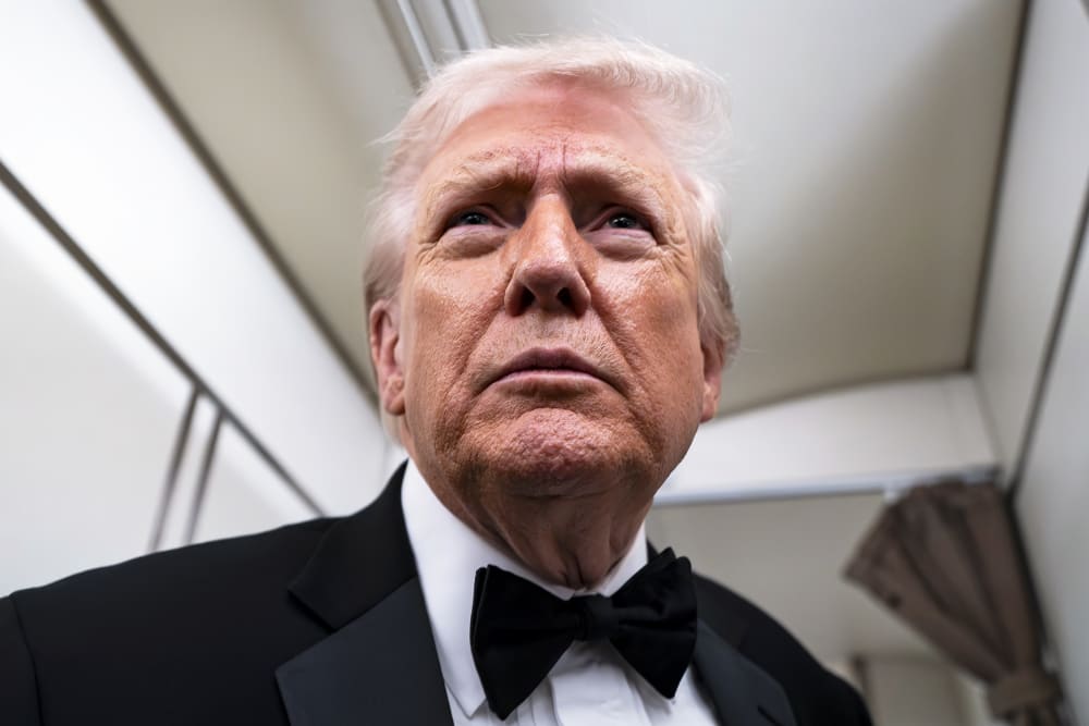 President Donald Trump speaks to reporters and members of the media on board Air Force One while flying in between Washington and West Palm Beach, Fla.