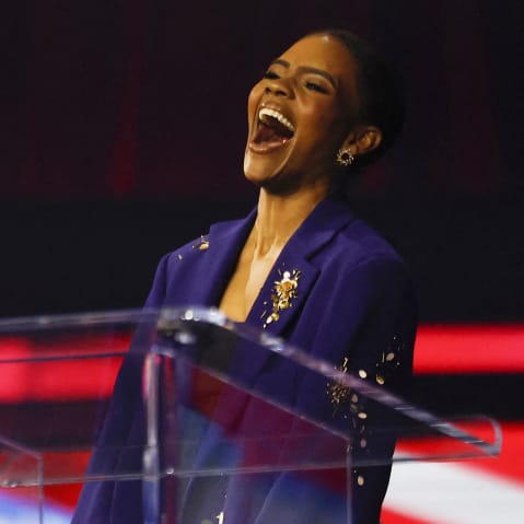Candace Owens laughs on stage.
