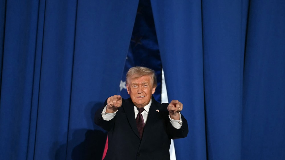 U.S. President Donald Trump steps on stage to speak at a political rally.