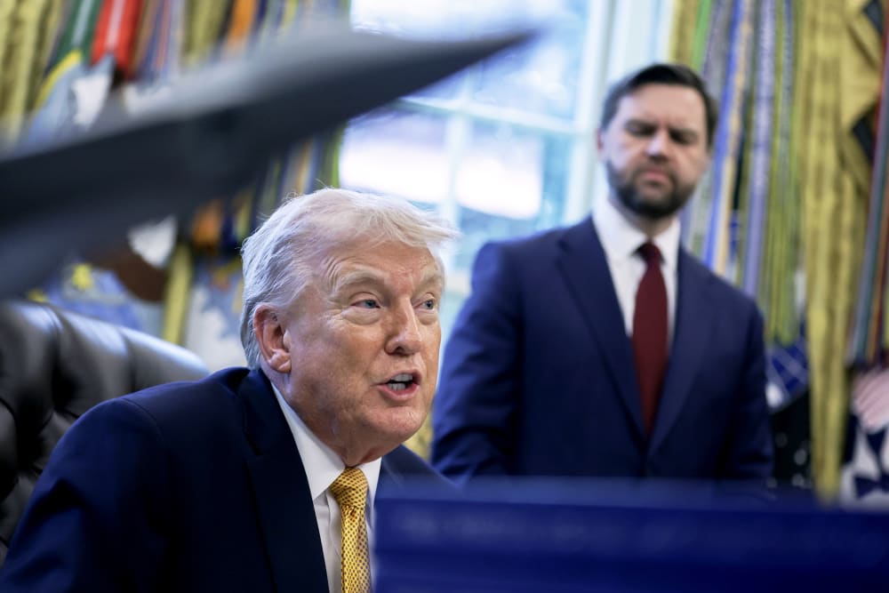President Donald Trump speaks to the media as Vice President JD Vance listens in the Oval Office of the White House.