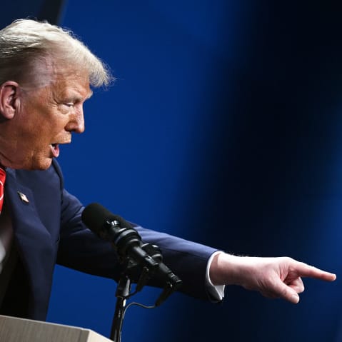 President Donald Trump gestures as he gives a press conference.
