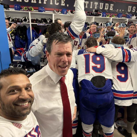 Kash Patel in a locker room with a group of men dressed for hockey are celebrating
