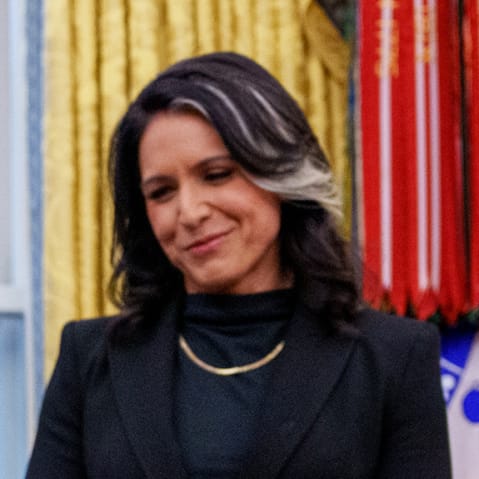 President Donald Trump signs Tulsi Gabbard's commission for her new role as Director of National Intelligence on Feb. 12, 2025 in the Oval Office at the White House.