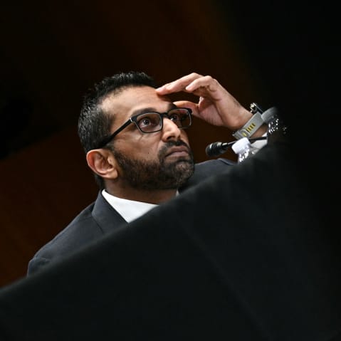 Kash Patel with his hand on his forehead.