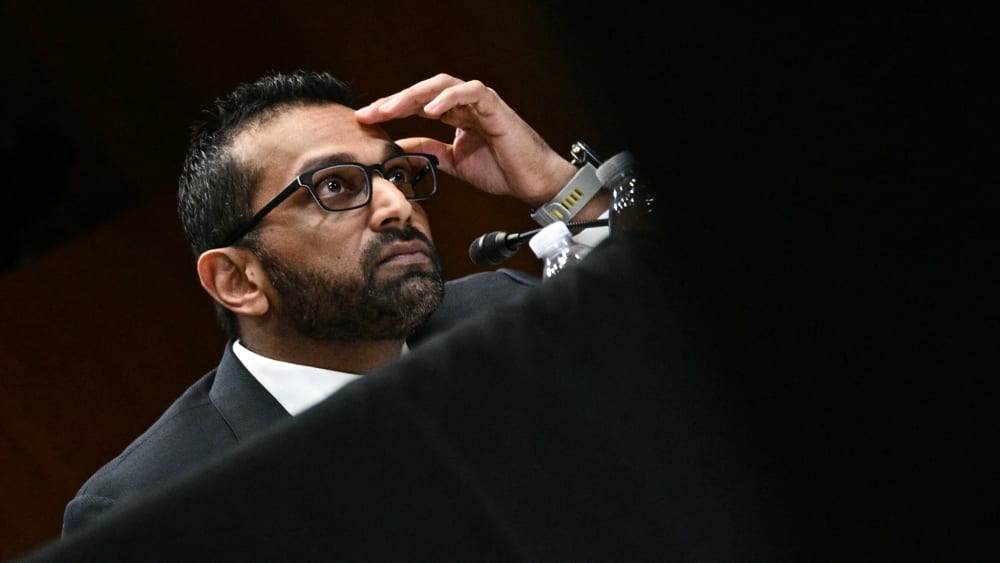 Kash Patel with his hand on his forehead.