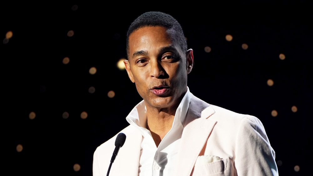 Don Lemon behind a microphone.