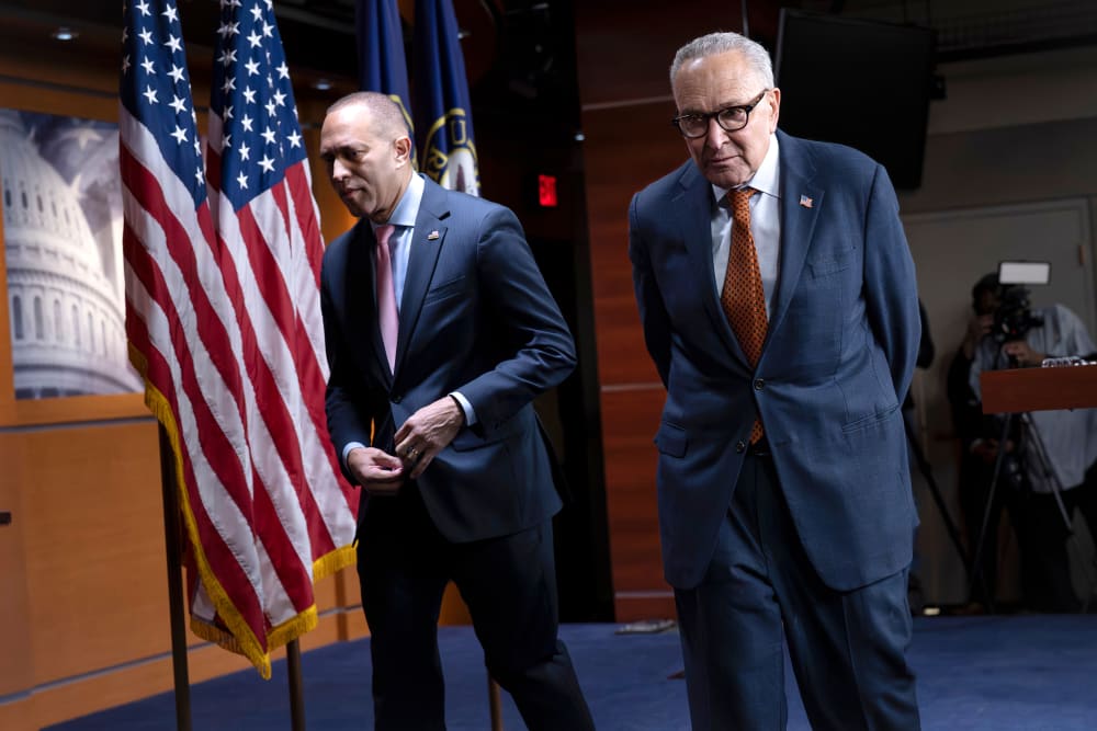 Hakeem Jeffries, left, Chuck Schumer walk out of a presser.