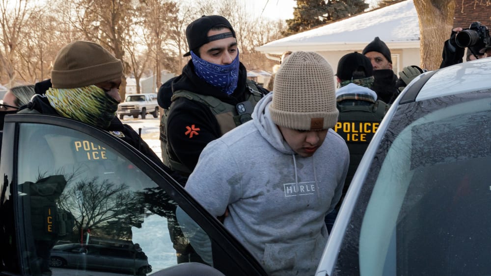 Immigration and Customs Enforcement (ICE) agents detain a young man while conducting federal enforcement operations on Jan. 27, 2026 in St. Paul, Minnesota.