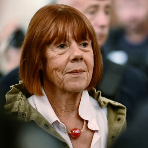 Gisele Pelicot stands among a group of people.