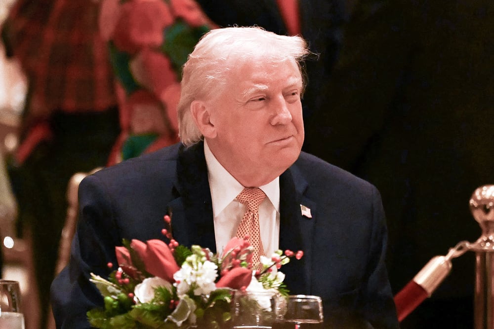 US President Donald Trump attends a Christmas dinner on Dec. 24 at his Mar-a-Lago resort in Palm Beach, FL.