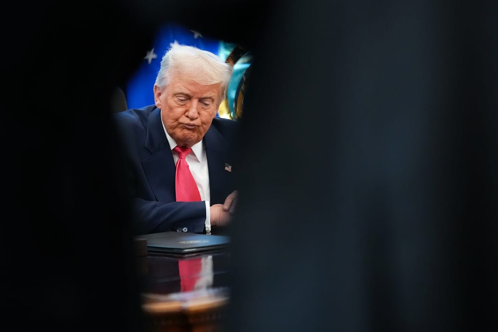 U.S. President Donald Trump answers questions from reporters in the Oval Office.