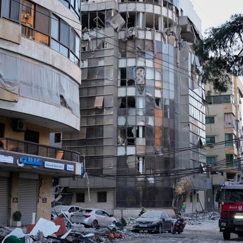 Debris covers a street beside an apartment building hit by an Israeli airstrike in Dahiyeh, Beirut's southern suburb.