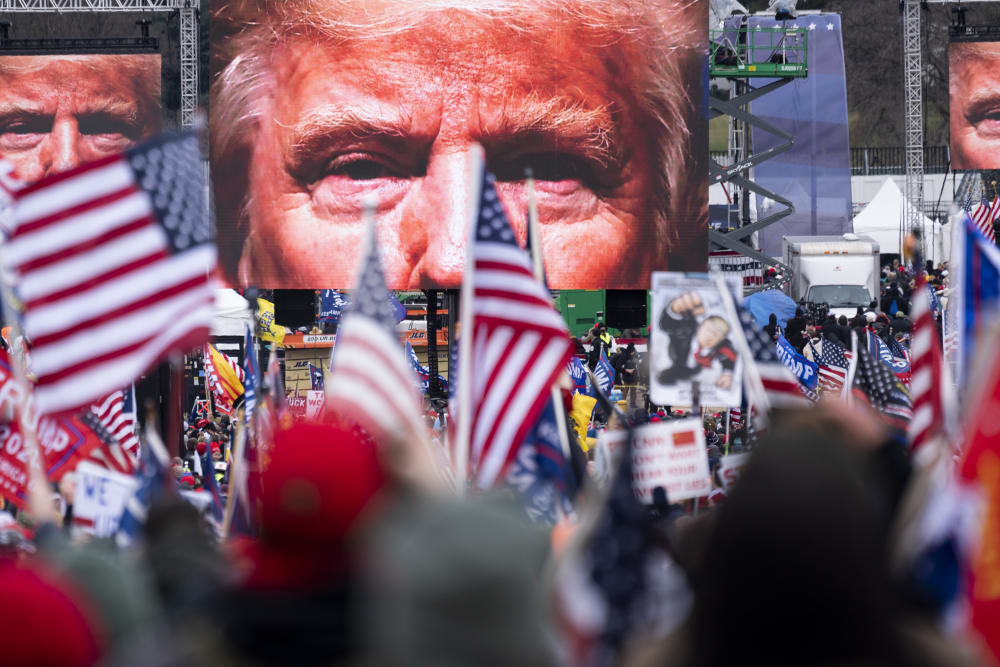 President Trump's closeup photo seen on video screens in front of a crowd at a rally.