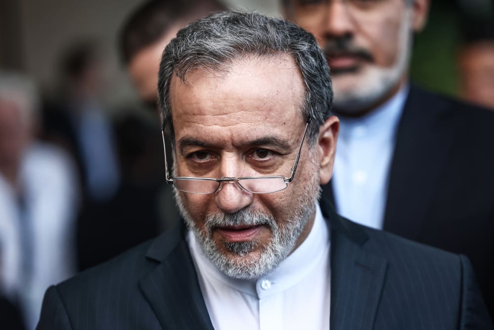 Iran's Foreign Minister Abbas Araghchi speaks to the media after a meeting.