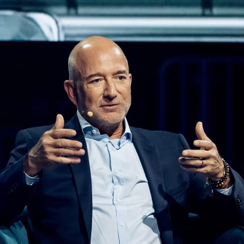 Jeff Bezos gestures with his hands.