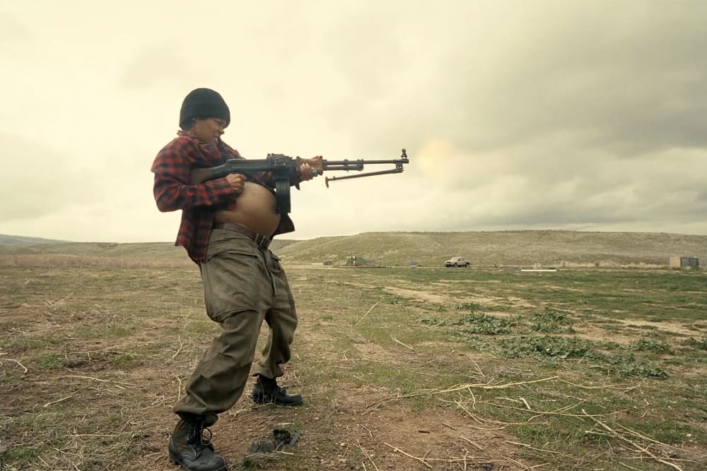 Teyana Taylor as Perfidia Beverly Hills firing a weapon while pregnant in the 2025 film "One Battle After Another."