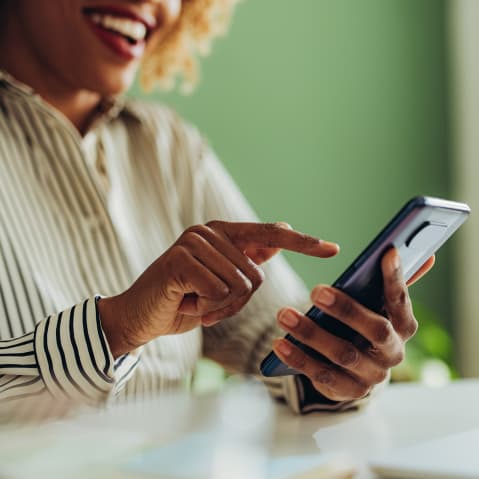 African American woman using social media on her phone.