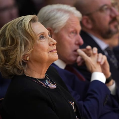 Hillary Clinton, left, and Bill Clinton sit during a conference.