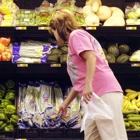 A shopper looks at produce at a Wal-Mart store in Rogers, AR.