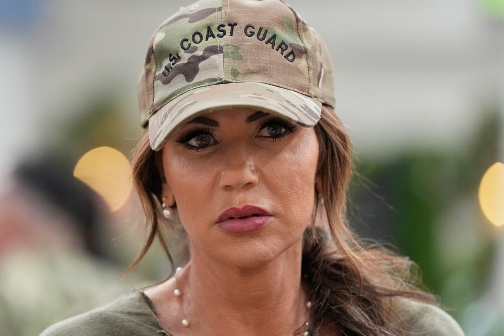 Homeland Security Secretary Kristi Noem in Bahrain wearing a "U.S. Coast Guard" hat.